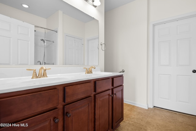 bathroom with vanity, tile patterned floors, and a shower with shower door