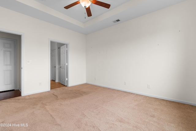 unfurnished bedroom with ceiling fan and light carpet