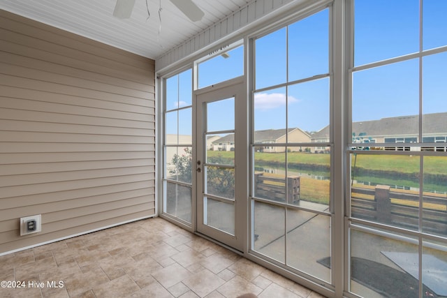 unfurnished sunroom with ceiling fan and wood ceiling