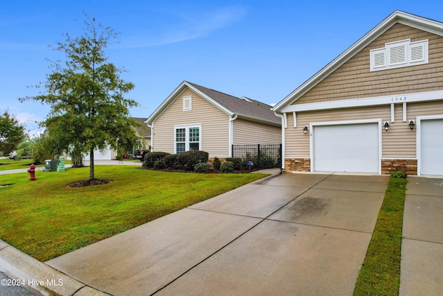 view of front of house with a garage and a front yard