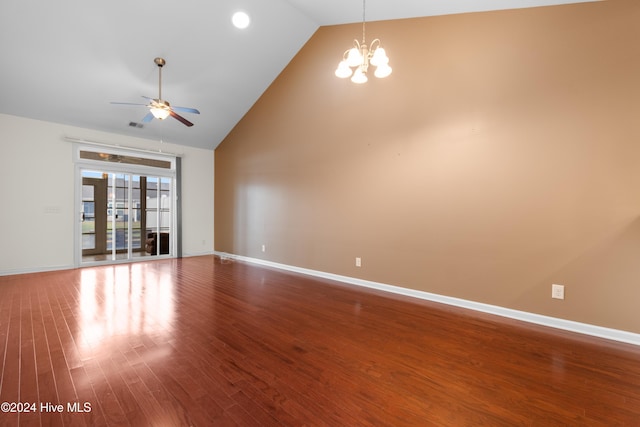 unfurnished living room featuring hardwood / wood-style flooring, ceiling fan with notable chandelier, and high vaulted ceiling