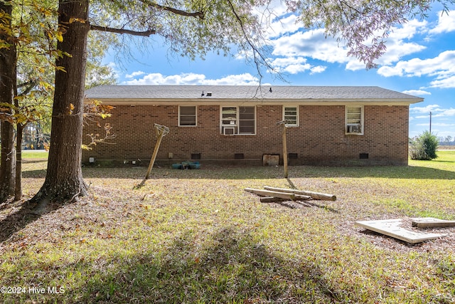 rear view of property with a lawn