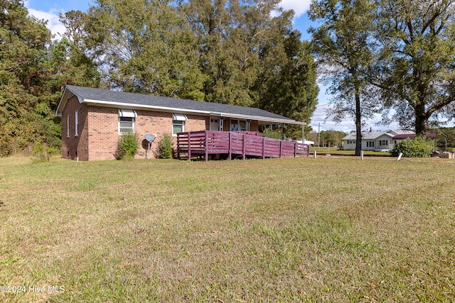 exterior space featuring a wooden deck and a front lawn