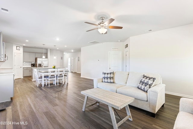 living room featuring hardwood / wood-style floors and ceiling fan