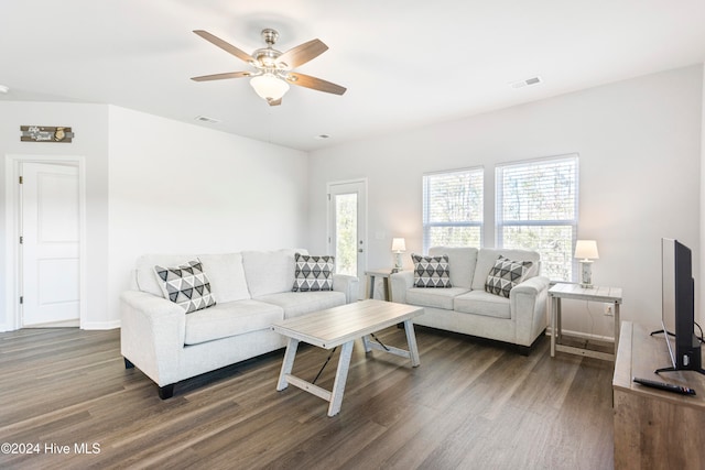 living room with ceiling fan and dark hardwood / wood-style flooring