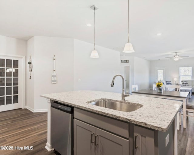 kitchen with pendant lighting, dishwasher, sink, ceiling fan, and light stone counters