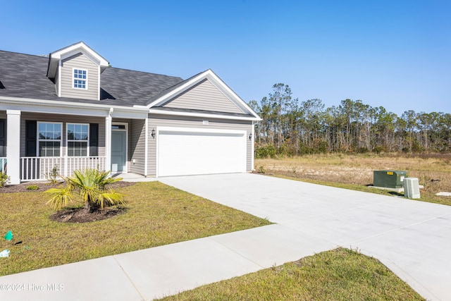 view of front facade featuring a porch, a garage, and a front lawn