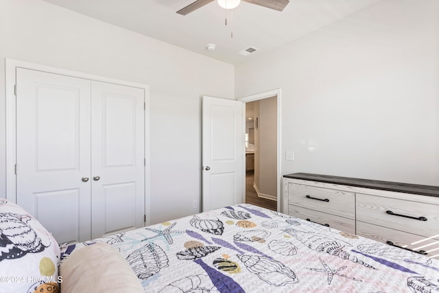 bedroom featuring hardwood / wood-style flooring, ceiling fan, and a closet