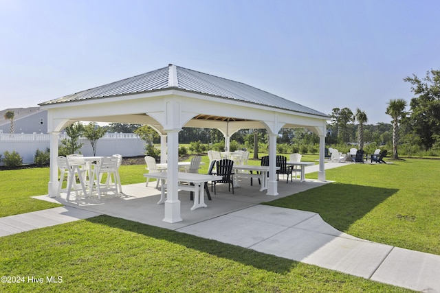 view of property's community with a gazebo, a patio area, and a yard