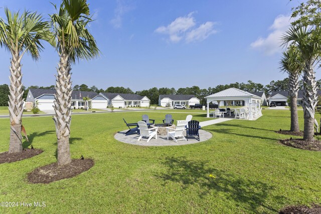 view of yard featuring a patio area and an outdoor fire pit