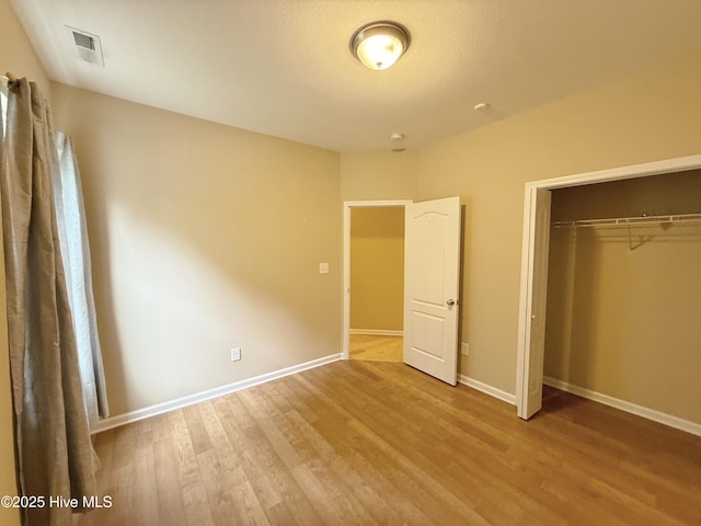 1535 Ghio Rd, Hamlet, NC 28345 - unfurnished bedroom featuring wood finished floors, a closet, and baseboards