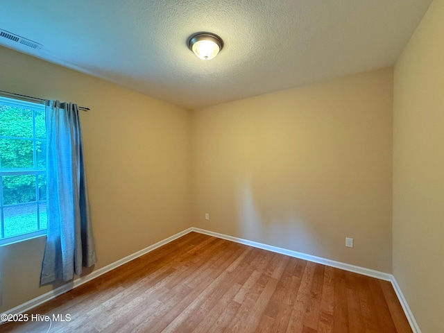 1535 Ghio Rd, Hamlet, NC 28345 - spare room with wood finished floors, baseboards, and a textured ceiling