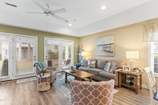 living room featuring a wealth of natural light, ceiling fan, and light hardwood / wood-style floors