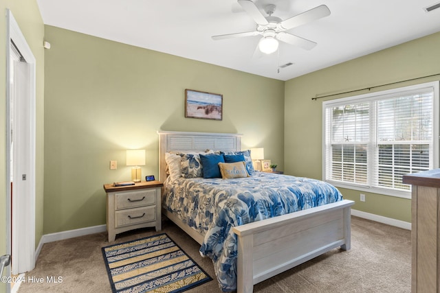 bedroom featuring ceiling fan, a closet, and light carpet