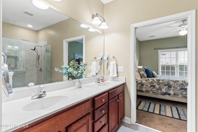 bathroom featuring ceiling fan, vanity, and a shower with shower door