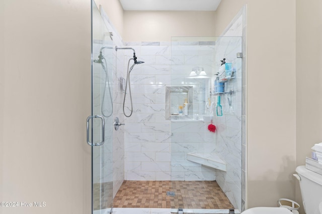 bathroom featuring an enclosed shower and toilet