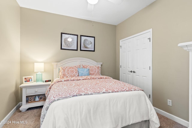 carpeted bedroom with ceiling fan and a closet