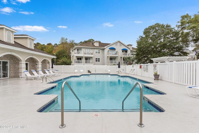 view of swimming pool with a patio