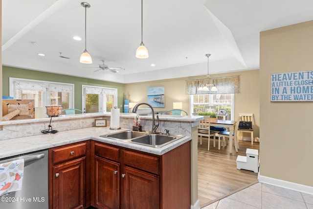 kitchen featuring ceiling fan, sink, stainless steel dishwasher, light hardwood / wood-style floors, and decorative light fixtures