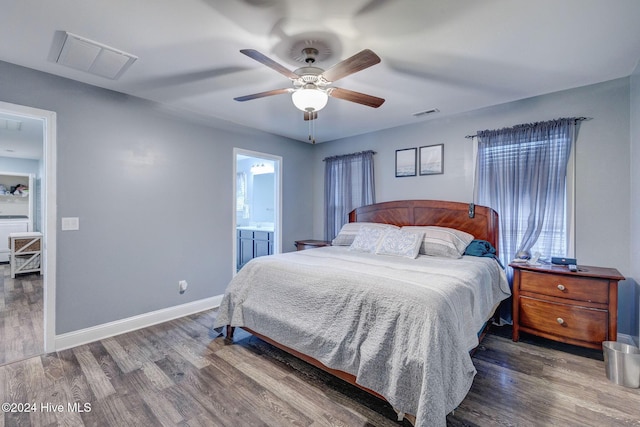 bedroom featuring wood finished floors, visible vents, and baseboards