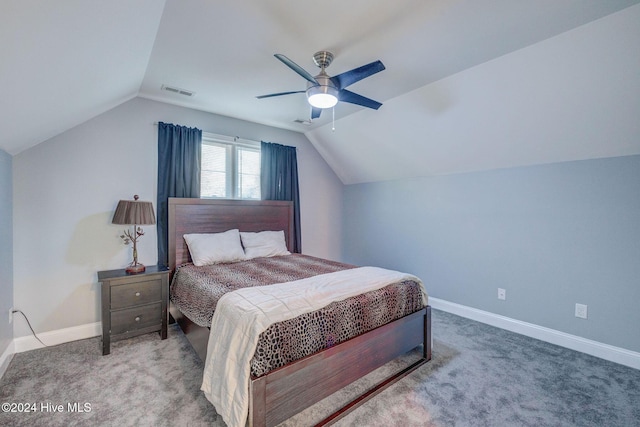 bedroom featuring carpet flooring, baseboards, visible vents, and vaulted ceiling