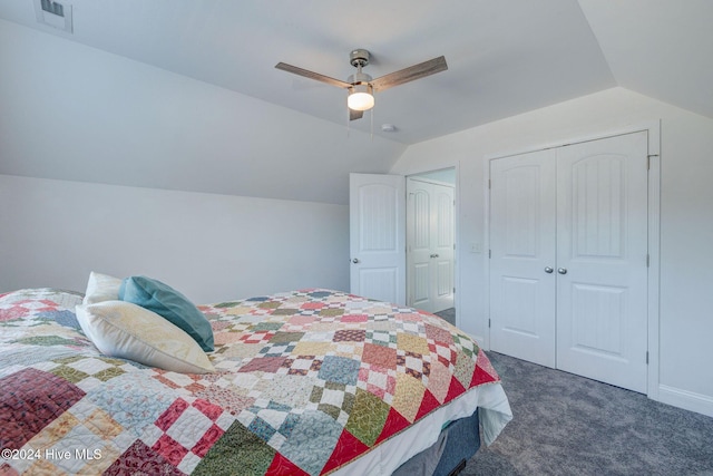 carpeted bedroom featuring visible vents, lofted ceiling, a closet, and a ceiling fan