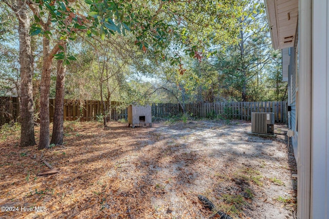 view of yard with central AC unit and a fenced backyard