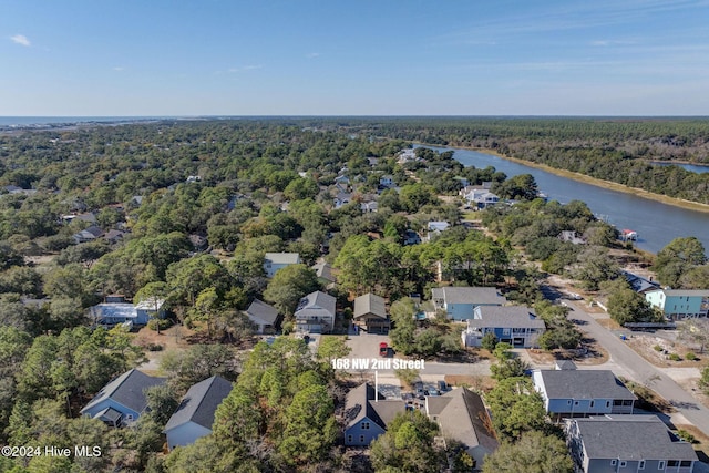 birds eye view of property with a residential view, a forest view, and a water view