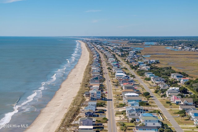 birds eye view of property featuring a view of the beach and a water view