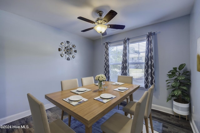 dining room with ceiling fan, dark wood-type flooring, and baseboards