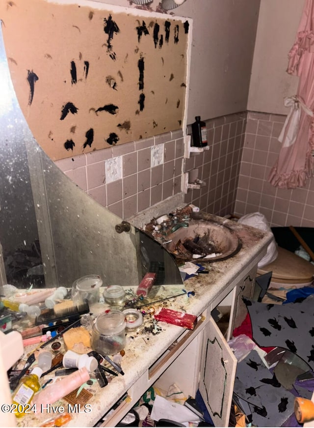 interior space featuring tile walls and sink