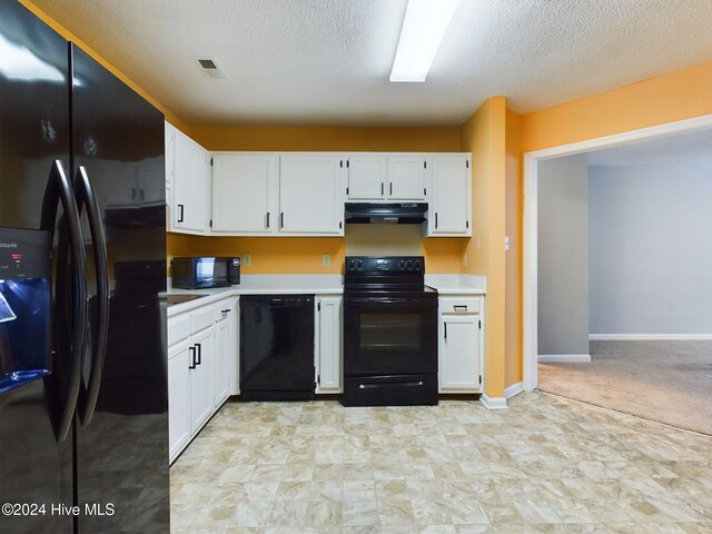 kitchen with white cabinets, black appliances, and a textured ceiling