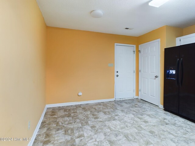 unfurnished room featuring a textured ceiling