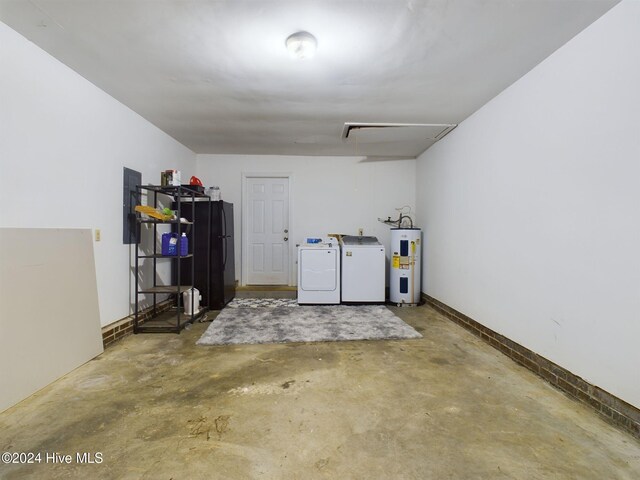 garage featuring washer and dryer, electric water heater, and electric panel