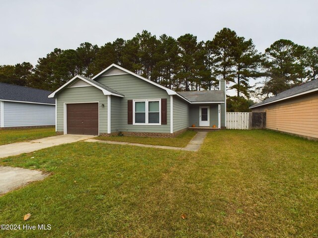 ranch-style home with a garage and a front lawn