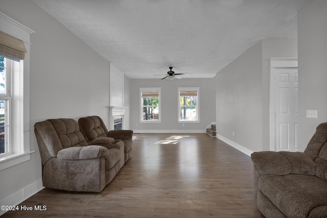 living room featuring a textured ceiling, hardwood / wood-style flooring, and ceiling fan