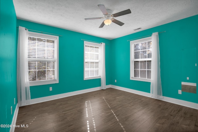 unfurnished room with ceiling fan, a textured ceiling, and dark hardwood / wood-style floors