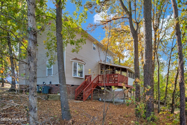 back of house featuring a wooden deck