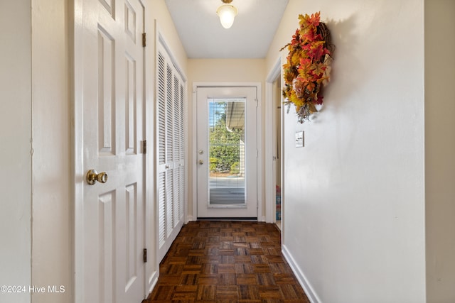 doorway with dark parquet floors