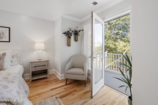 bedroom featuring access to outside, ornamental molding, and light wood-type flooring