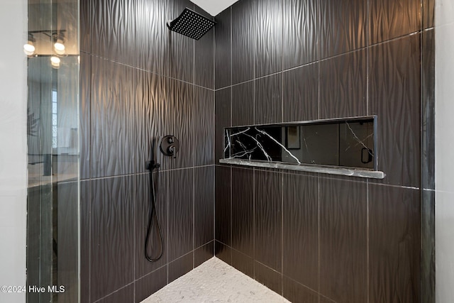 bathroom with tiled shower