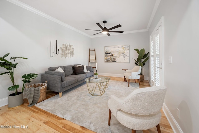 living room with hardwood / wood-style flooring, ceiling fan, and ornamental molding