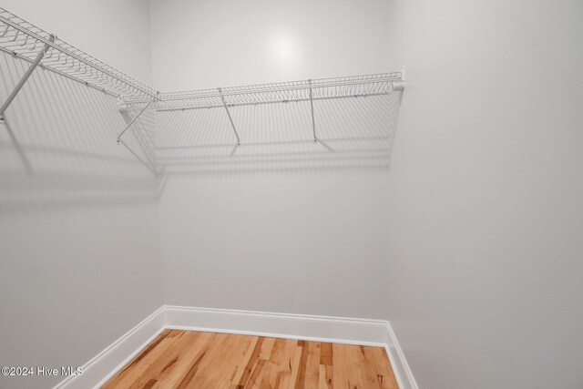 bathroom with vanity, walk in shower, and ornamental molding