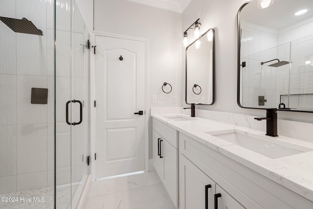 full bath featuring marble finish floor, ornamental molding, a stall shower, and a sink