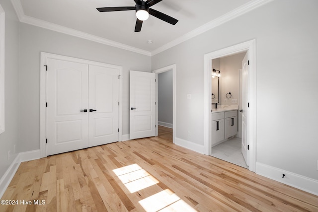 unfurnished bedroom with ceiling fan, light wood-type flooring, ornamental molding, connected bathroom, and a closet