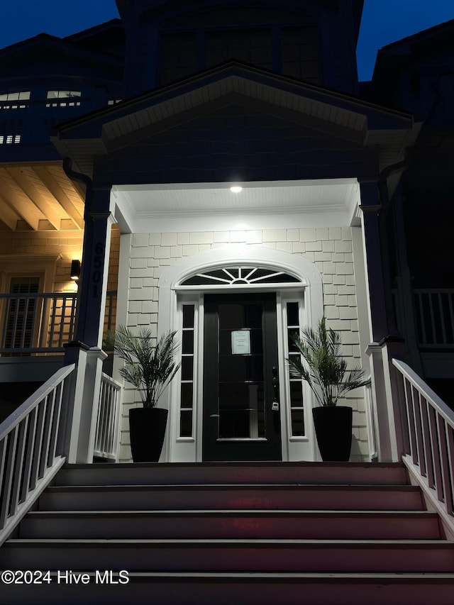 view of exterior entry at twilight