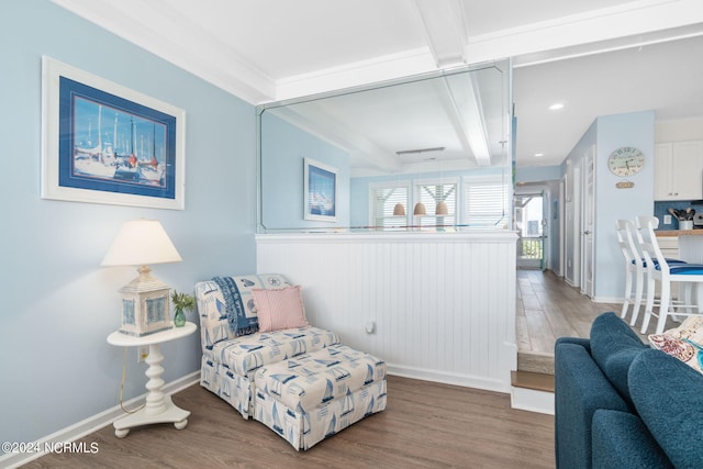 living area featuring hardwood / wood-style flooring and beamed ceiling