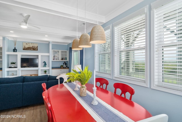 dining room with ceiling fan, a wealth of natural light, dark hardwood / wood-style floors, and beamed ceiling