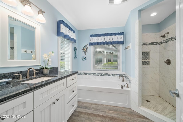 bathroom with vanity, separate shower and tub, and hardwood / wood-style floors