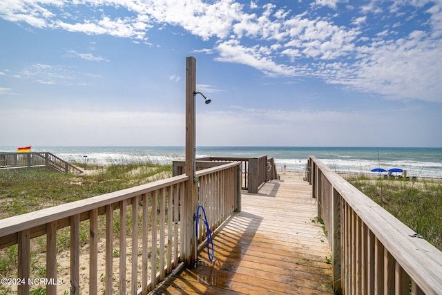 view of community with a view of the beach and a water view